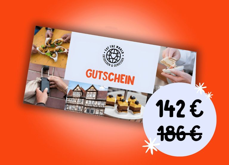 Rechteckiges Gutscheinpaket mit Lebensmittelbildern, "Gutschein"-Text und einem von 186€ auf 142€ reduzierten 4 für 3 Rabatt-Preis auf orangem Hintergrund.